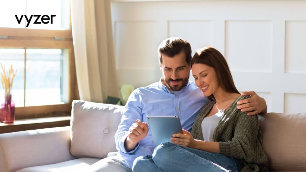 Couple using Vyzer wealth management app on tablet at home to redefine their personal finance strategy